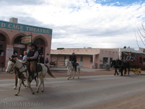 1996 Ford C-350 (Centurion Conversions) - A horse-drawn stagecoach travels down a street in front of the historic Bird Cage Theatre.
