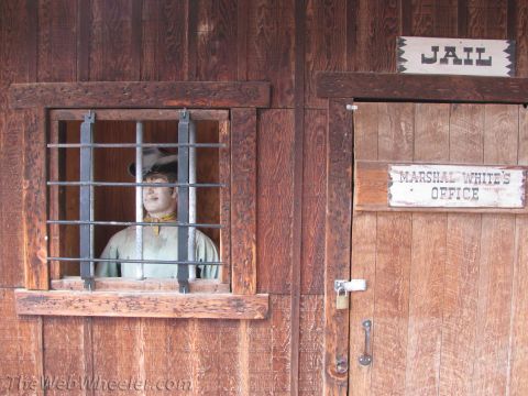 1996 Ford C-350 (Centurion Conversions) - A mannequin dressed as a prisoner is seen behind bars in a jail cell next to the Marshal's office.