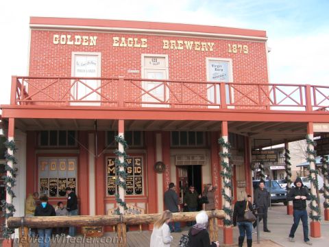 1996 Ford C-350 (Centurion Conversions) - A historic-looking building with a "Golden Eagle Brewery 1879" sign and signs for food and live music.
