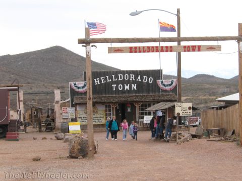 1996 Ford C-350 (Centurion Conversions) - Visitors enter Helldorado Town, a western-themed attraction, under a wooden archway.