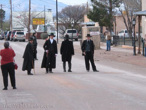 1996 Ford C-350 (Centurion Conversions) - People dressed in old west attire pose for photos on a dusty street with a Wells Fargo sign in the background.