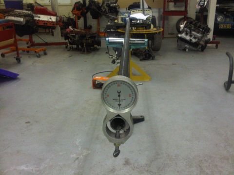 1996 Ford Bronco - Dial indicator gauge in a workshop setting with various engine components in the background.