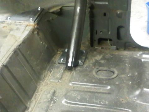 1996 Ford Bronco - Close-up of the interior floor showing a roll cage mount and bracing, with no visible year indicators.