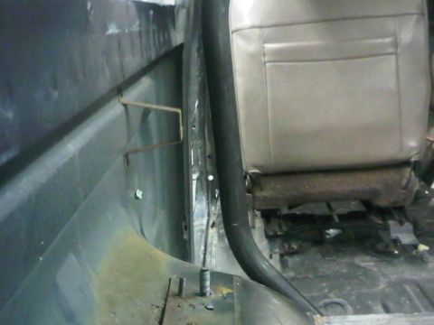 1996 Ford Bronco - View of the interior, focusing on the seat and a roll bar, with visible wear and tear.