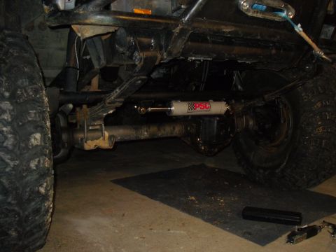 1984 Ford Bronco II - The underside of a vehicle is shown, focusing on the steering and suspension components.