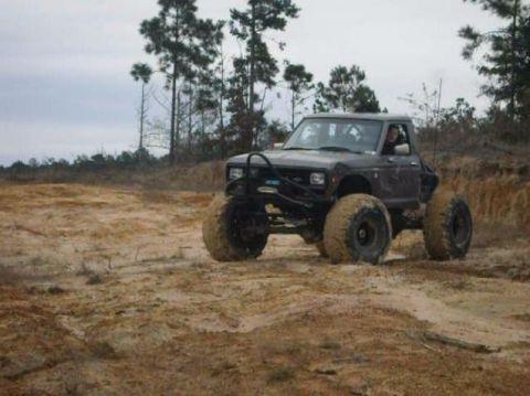 1984 Ford Bronco II - This modified 1984 Ford Bronco II navigates a muddy, off-road terrain.