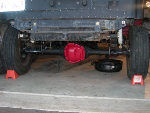 1991 Jeep Wrangler - Rear axle assembly with red differential cover and suspension components.