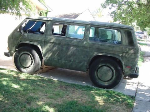 1991 Ford Bronco - This van has a custom camouflage paint job and appears to be modified for off-road use.