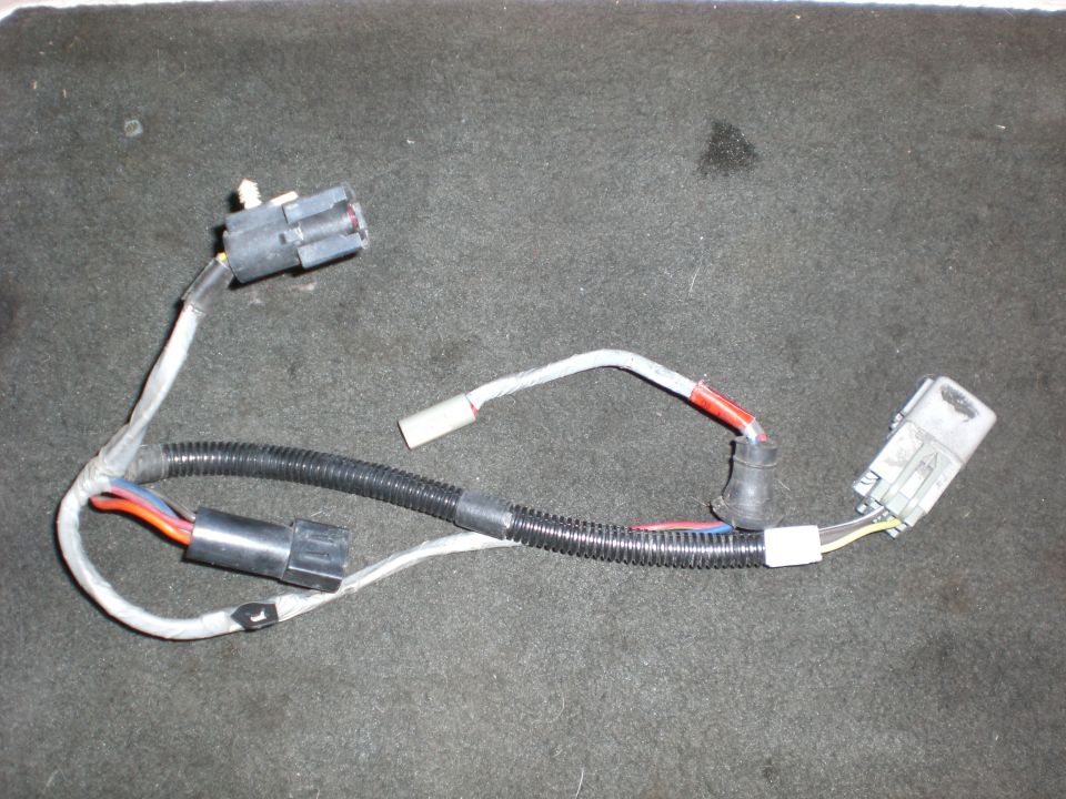 Wiring harness with multiple connectors and black protective tubing