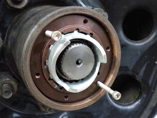 Front hub with locking hub removed, showing splined axle stub, retainer, and screws