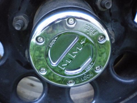 1989 Ford Bronco - Close-up of a chrome MileMarker hubcap, indicating 'LOCK' and 'FREE' settings.