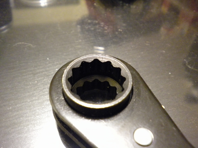 Close-up of a black 12-point ratcheting box-end wrench head