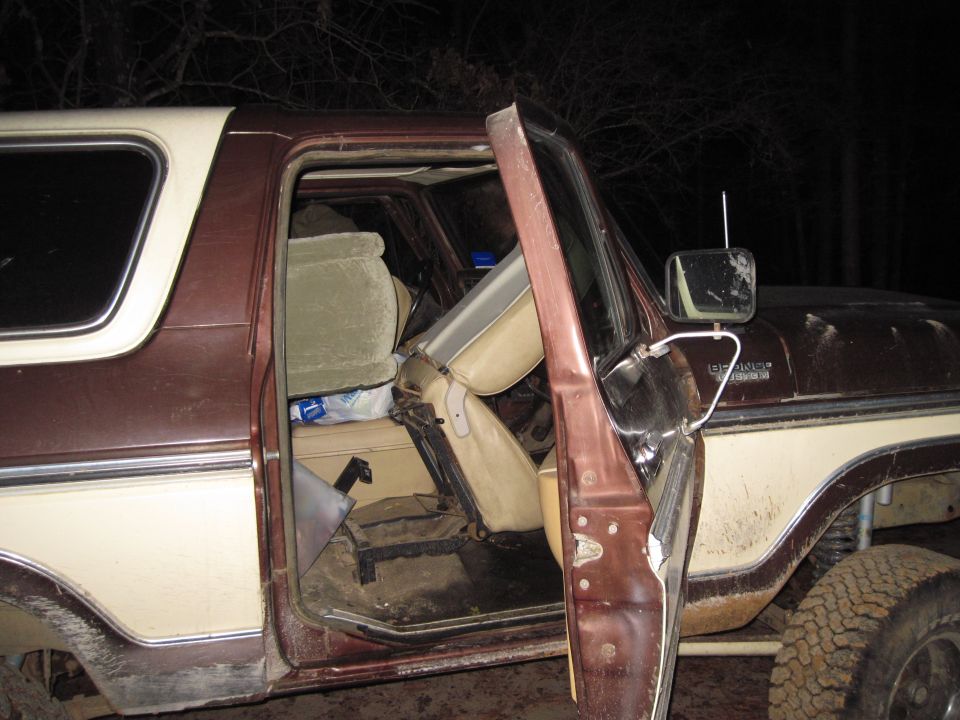 Open door of a two-tone brown and tan SUV at night