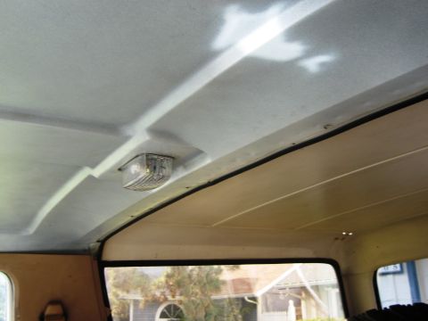 1986 Ford Bronco - The interior ceiling of a vehicle shows a dome light and the texture of the headliner.