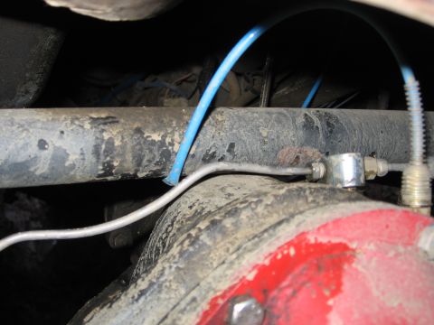 1989 Ford Bronco - Undercarriage view showing brake lines connected to the rear axle assembly.