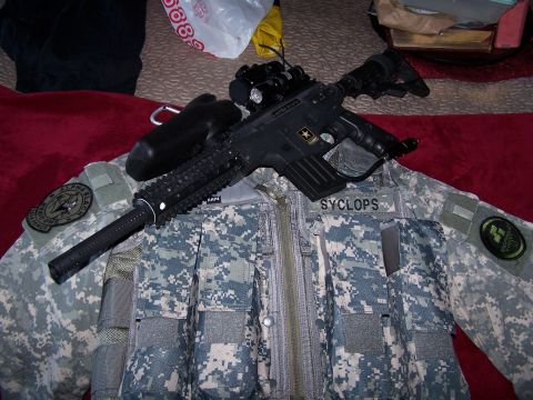 1986 Ford Bronco - Tactical vest and paintball gun are laid out, with various patches visible.
