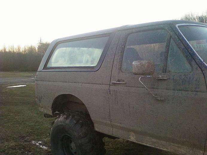 Mud-covered 1990 Ford Bronco side view