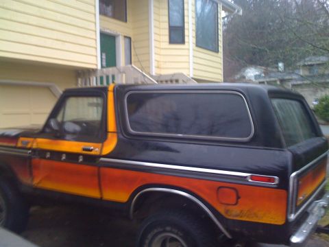 1978 Ford Bronco - This 1978 Ford Bronco has a distinctive orange and black stripe pattern along its side.
