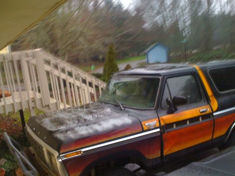 1978 Ford Bronco - This 1978 Ford Bronco features a distinctive orange and yellow stripe along its side.