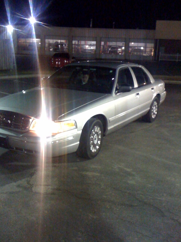 Silver 2005 Ford Crown Victoria parked at night
