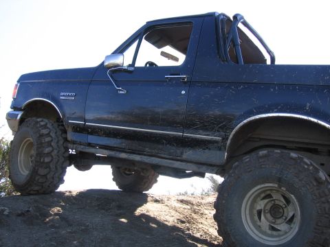 1989 Ford Bronco - This 1989 Ford Bronco is shown with a lifted suspension and large off-road tires, suggesting it is prepared for terrain.