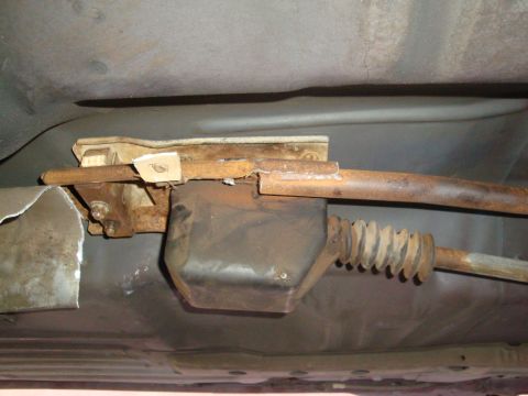 1993 Ford Taurus - Close-up of the undercarriage, focusing on the exhaust system and a protective rubber boot.