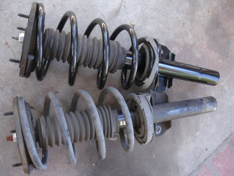 1992 Ford Taurus - Two automotive front strut assemblies are shown, one appearing newer than the other.