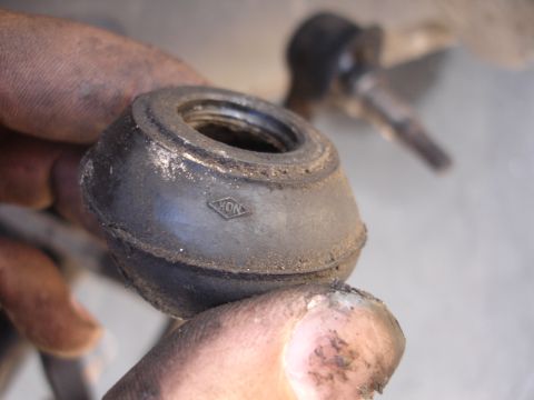 1992 Ford Taurus - A close-up shows a rubber suspension component bearing the NOK logo, held by a person's hands.