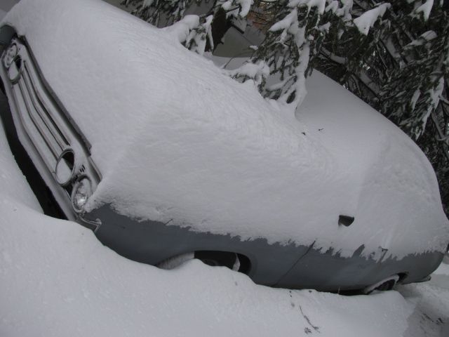 1969 Ford Torino front grille and headlights covered in snow