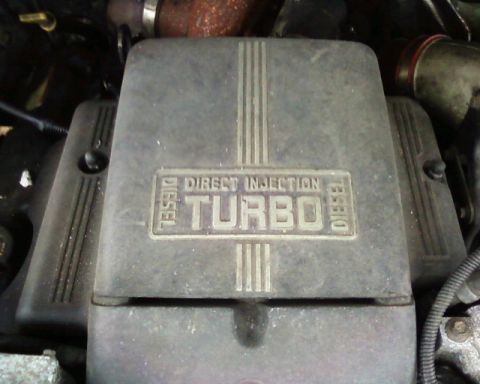 1984 Ford Bronco II - Close-up of a diesel turbo engine cover with direct injection text.