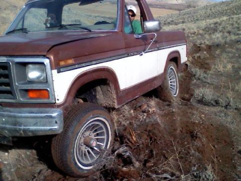 1985 Ford Bronco - This 1980s Ford Bronco is shown tackling a challenging off-road path.
