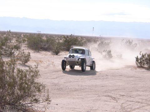 1996 Ford C-350 (Centurion Conversions) - Off-road Volkswagen Beetle driving through a dusty desert landscape.