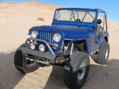 1996 Ford C-350 (Centurion Conversions) - Modified Jeep with large tires and off-road accessories parked in the desert.