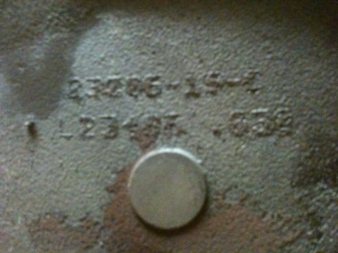1972 Ford Ranchero - Extreme close-up of the stamped identification numbers on a cast piston crown, showing a part number ending "-15-" and an oversize spec rea…