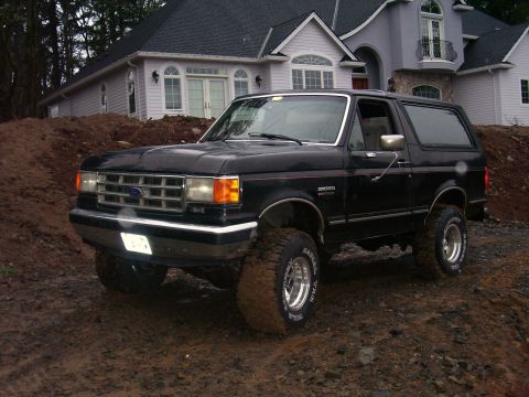1988 Ford Bronco - This black 1988 Ford Bronco is shown off-road on a construction site.