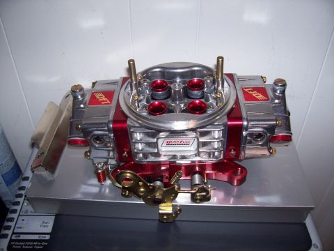 1978 Ford F-150 - A close-up view of a Quick Fuel Technology carburetor, a polished chrome and red finish.
