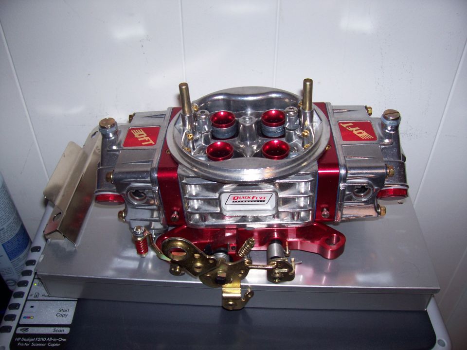 Red and chrome carburetor with Quick Fuel Technology branding