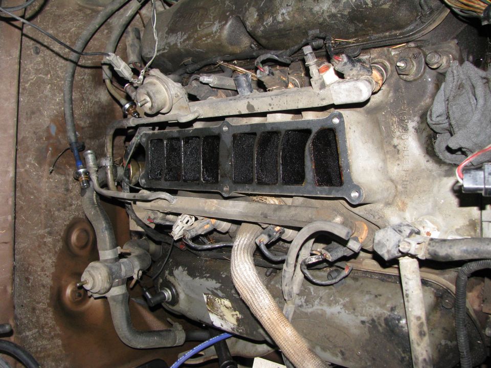 fuel, electrical, and vacuum lines removed.  all bolts loose.  time to yank it.
