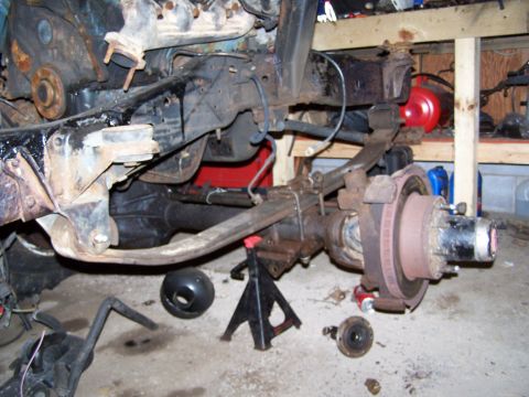 1989 Ford F-150 - Disassembled truck chassis and suspension components are visible in a workshop setting.