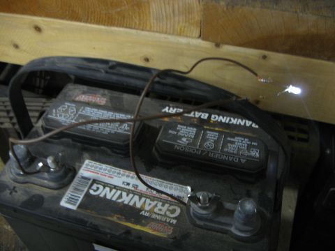 2004 Aston Martin Virage - A car battery is wired to two LEDs, one of which is brightly lit, suggesting a simple electrical circuit.