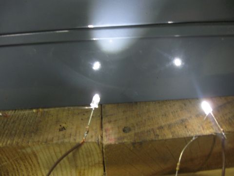 2004 Aston Martin Virage - Several LEDs are wired to wooden beams, illuminating the area with bright light.