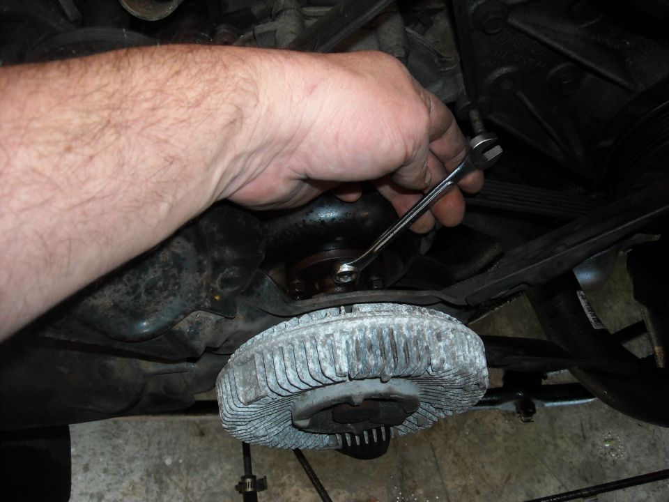 an 11MM box end wrench was used for the fan bolts. I found it easier to do this while the belt was still on.
I like the box end because the chances of it slipping are removed.
The fan itself as a spot where the blades are spaced further apart. You can spin the fan so that the gap is at the bolt you need to unscrew. It makes it easier.