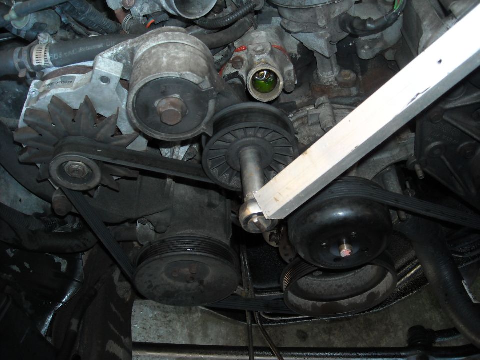 A 5/8 socket, a solid socket wrench and a 4 foot leverage makes quick work of the belt.