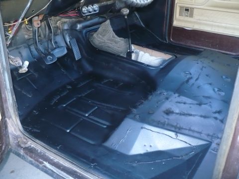 1979 Ford Bronco - The interior floor of the vehicle appears to have been recently cleaned or treated.