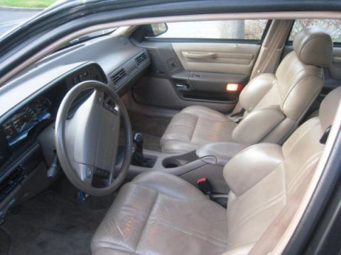 1993 Ford Taurus - Interior view of a 1993 Ford Taurus, highlighting its tan leather seats and dashboard.