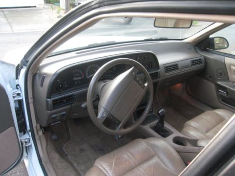 1993 Ford Taurus - Interior view of a sedan from the early 1990s, a tan dashboard and leather seats.