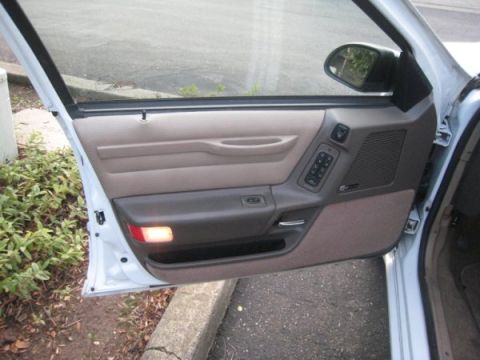 1993 Ford Taurus - Close-up of a car's interior door panel, showing the window controls and speaker.