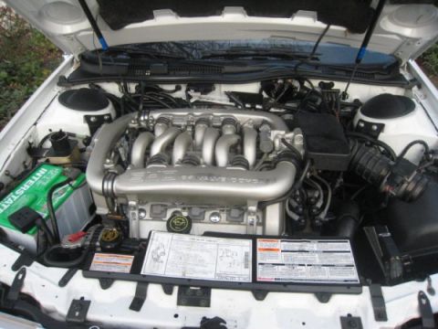 1993 Ford Taurus - Engine bay of a 1993 Ford Taurus, showing the V6 engine and associated components.