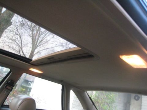 1993 Ford Taurus - View of the car's interior, focusing on the sunroof and headliner, with overhead lights illuminated.