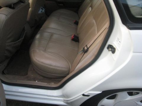 1993 Ford Taurus - Rear interior view of a 1993 Ford Taurus, showing the seats and door frame.